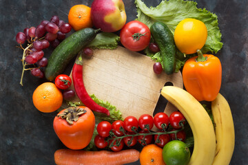 Fresh vegetables and fruits on a black background. Vitamins and minerals. Top view. Make room for your text.