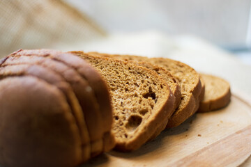 Fresh bread on the table close-up in flour scattering. Fresh bread on the kitchen table. Healthy...