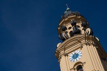 Close-up of the top of one of the towers of the Theatinerkirche (Theatine Church) in Munich, Germany, against a blue sky