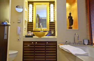 Wellness spa oasis bathroom inside luxury suite cabin stateroom with sink, mirror, bathtub, shower...
