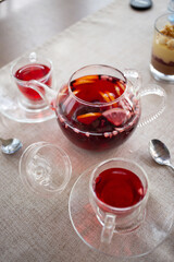 Fruit tea with slices of orange, lemon, red berries