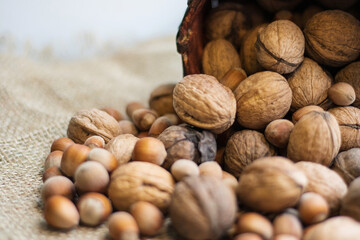 Nuts. Walnut kernels and whole walnuts on a table. Wooden background. Top view, flat lay with copy space.