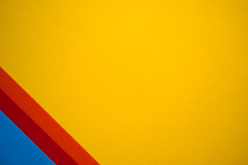 Yellow , blue, orange and red geometric abstract colored paper textured background
