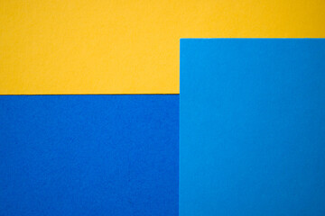 Fototapeta premium Blue and yellow abstract colored paper textured background, template, greeting card, book cover