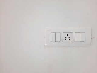 indian electric power socket with switches in white color on white wall