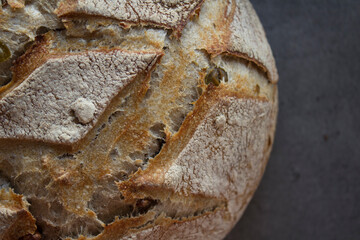 Sourdough bread texture close up. Crusty bread with olives and nuts. Healthy eating concept. 