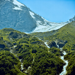 Large and small rivers and waterfalls in North Ossetia against the backdrop of majestic mountains....
