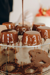 Baker decorating dessert, by filling chocolate on it.