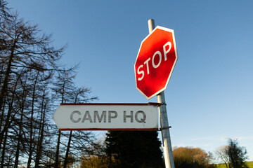 Stop, Military Camp Head Quarters (HQ) to the left sign