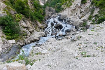 Large and small rivers and waterfalls in North Ossetia against the backdrop of majestic mountains. Republic of North Ossetia - Alania