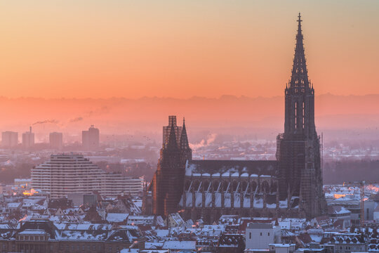 Minster of Ulm and City ulm from above at sunrise sunset with alps mountains in the background and mist, fog in the valley, in the morning evening baden- w&uuml;rttemberg, germany, german