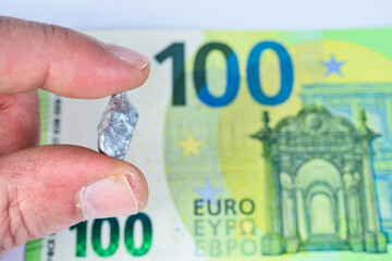 Silver nugget in hand with euros