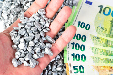 Silver nuggets in hand with money