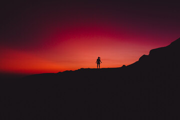 Bright sunset and alone silhouette of people