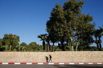 Pedestrian walking past the Royal Palace in Fes, Morocco. 11.10.2019