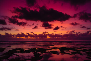 Fototapeta na wymiar Colorful sunset or sunrise with clouds at beach.
