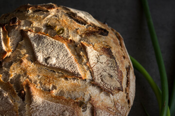 Sourdough bread texture close up. Crusty bread with olives and nuts. Healthy eating concept. 