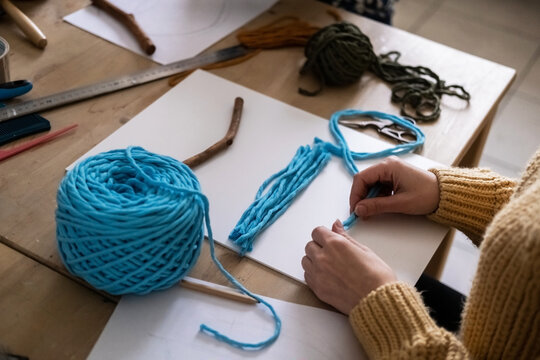 Lesson, the process of creating macrame, weaving from threads. Hand made. A working space for creativity. Knitting knots.