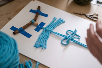 Lesson, the process of creating macrame, weaving from threads. Hand made. A working space for...