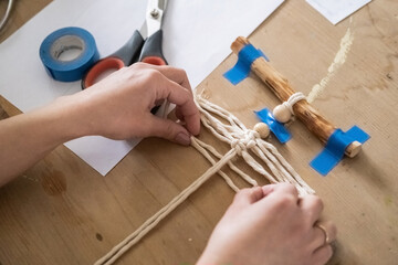 Lesson, the process of creating macrame, weaving from threads. Hand made. A working space for...