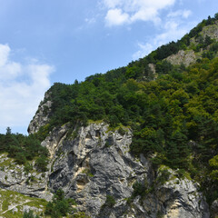 Beautiful mountain peaks of the North Caucasus against the backdrop of a blue cloudy sky. Republic of North Ossetia - Alania