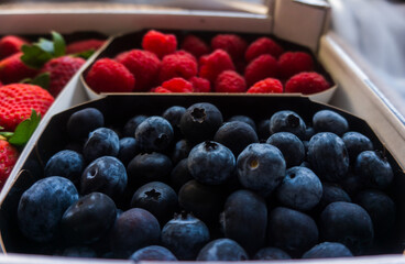 Delicious and healthy box of strawberries, blueberries and raspberries