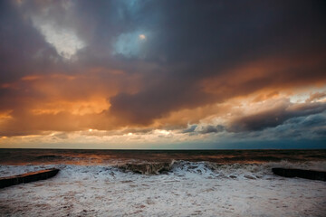 Obraz premium Abstract and colorful storm clouds. Sea sunset. A storm at sea. The waves hit the shore.