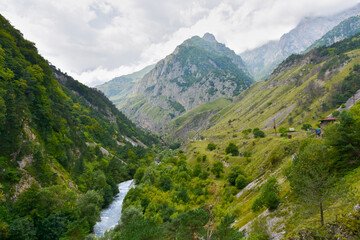 Fototapeta na wymiar Large and small rivers and waterfalls in North Ossetia against the backdrop of majestic mountains. Republic of North Ossetia - Alania