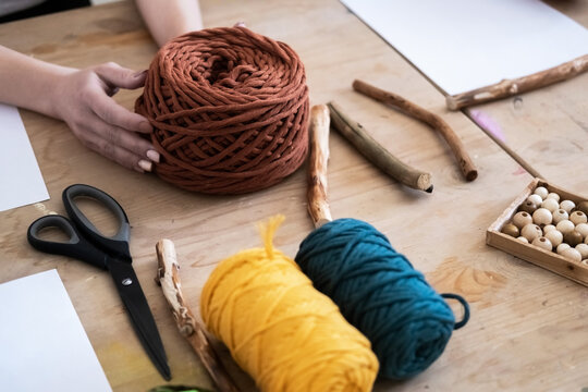 Tools and skeins of colorful threads for creating macrame with your own hands. Lesson, master class, training.