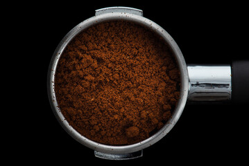 Coffee Preparation, close-up portafilter with fresh ground coffee top view