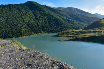 Panorama of the Zaramag reservoirs in the mountains of the North Caucasus on a hot summer day. Republic of North Ossetia - Alania