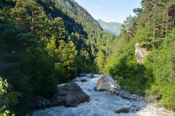 Large and small rivers and waterfalls in North Ossetia against the backdrop of majestic mountains....