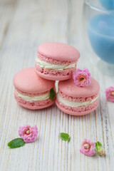 Pink macaroons with the glass pot of blue masala tea