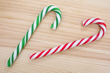 Candy canes on wooden background