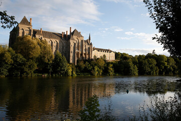 Fototapeta premium Sarthe river and Solesme abbey, France. 21.04.2018