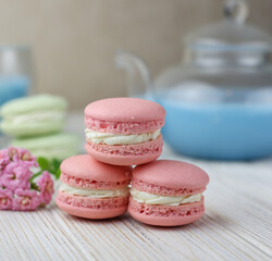 Pink macaroons with the glass pot of blue masala tea