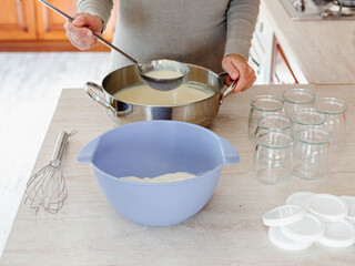 Woman making yogurt at home. Soy yogurt, vegan recipe. Cooking at home