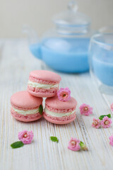 Pink macaroons with the glass pot of blue masala tea