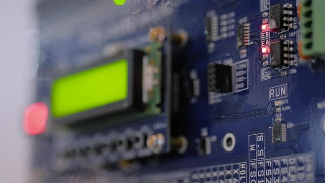 Purple printed circuit board - pcb for elevator with digital display module at lift exhibition, trade show - close up view. Technology and electronic concept