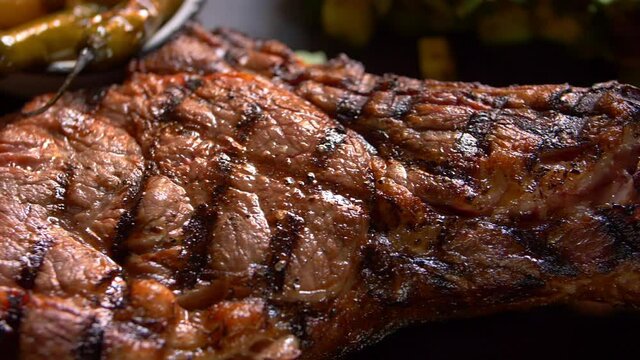 Close-up of grilled meat on a black plate