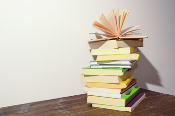 Stack of books on dark rustic table. Free space for text
