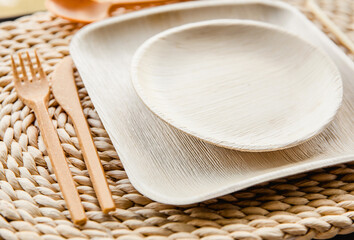 Set of dry biodegradable empty new palm leaf plates and edible fork, knife, spoon and bamboo straw....