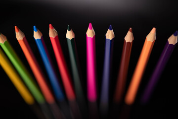 Group of colored pencils on black background