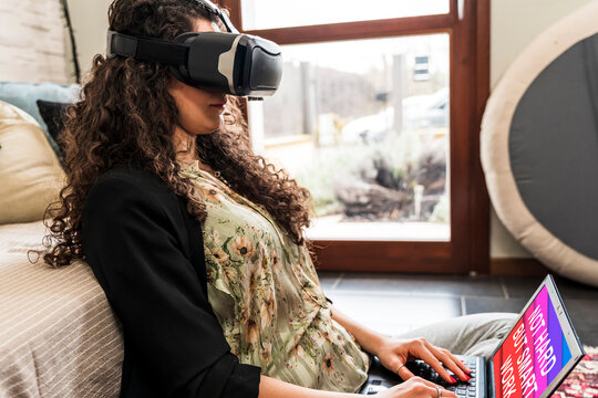 young woman working at home with augmented reality viewer