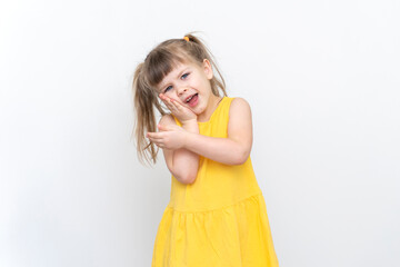 a little girl in a yellow dress has a toothache