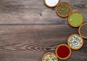 Oriental and europeans colorful spices and herbs for healthy cooking. Copy space for your text on wooden background.
