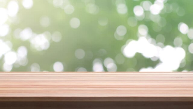 Close up Top Wood table bar and nature tree bokeh blurred background. At morning time and beautiful nature sun light, Top wood table space area for products shows. 4096x2304. 4K UHD. Video Clip