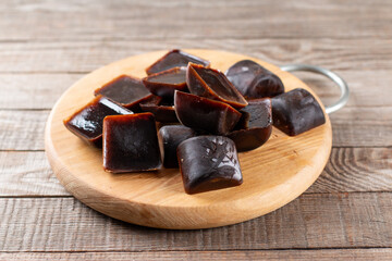 Ice cubes made with coffee in ice cube tray to prepare refreshing coffee drinks, close up on a table