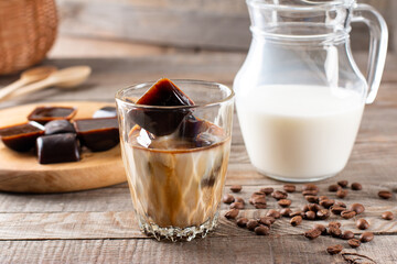 Ice coffee with milk in a glass on a table