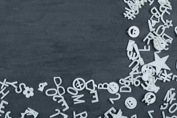 White plastic letters, icons and symbols on grey background